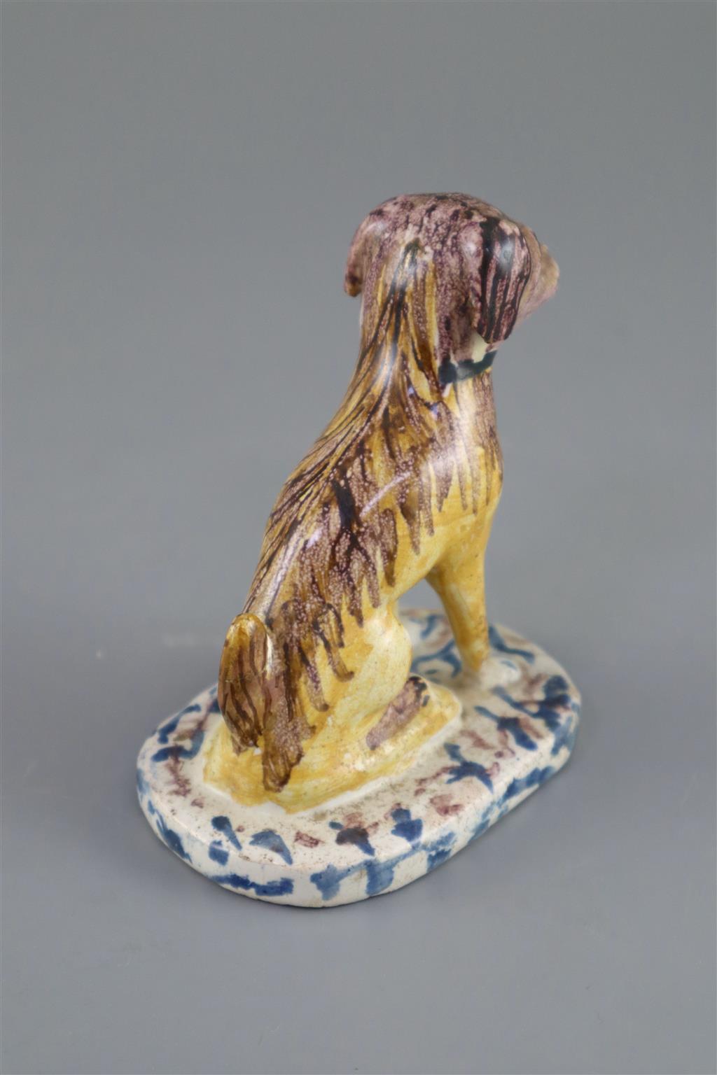A Continental faience model of a seated dog, mid 18th century, possibly Brussels,